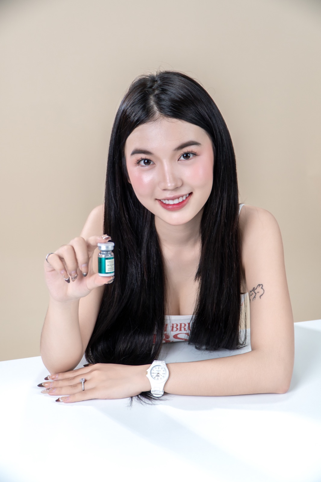 Model holding a DANIQUE vial